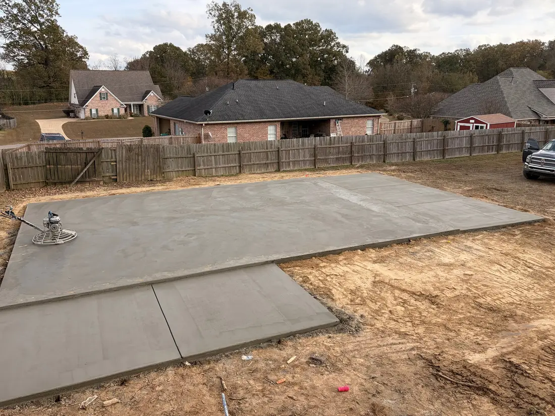 The same backyard slab poured and finished, curing inside its forms