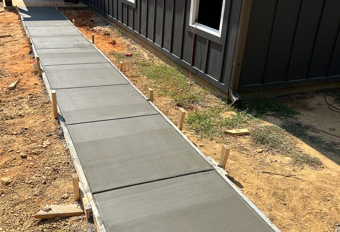 Sloped paver-style walkway along a modern building