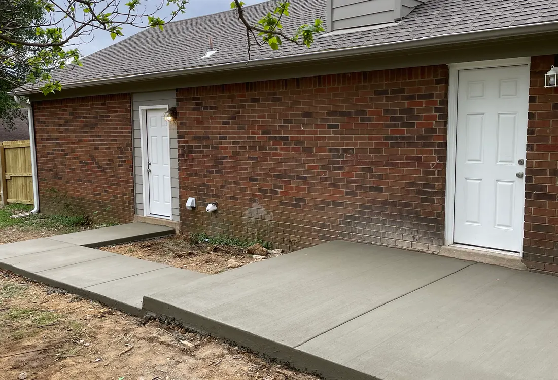 Side walkway poured along a brick house