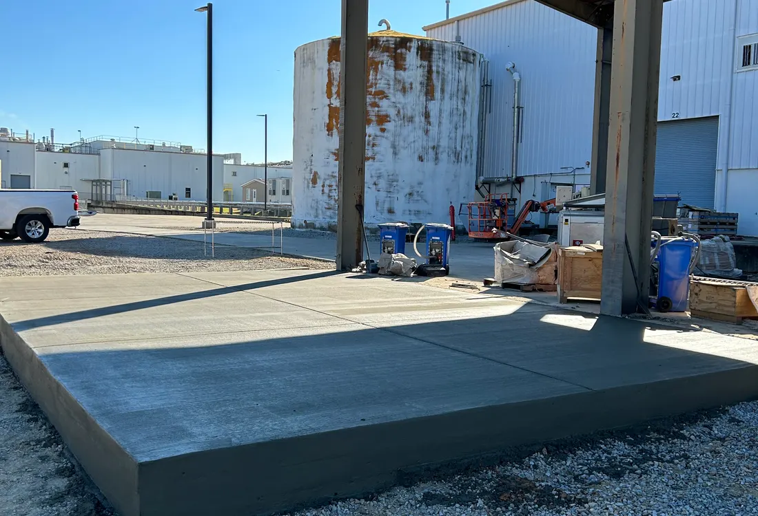 Small commercial pad poured beside a fuel canopy