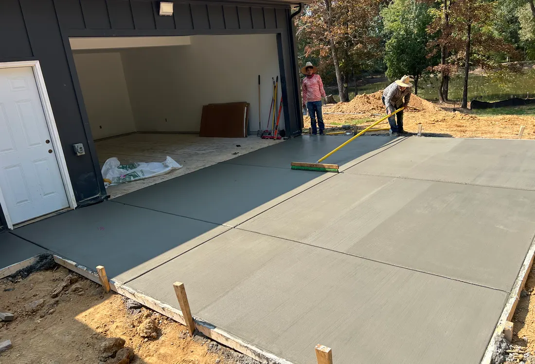 Fresh garage apron and pad at a dark-sided building