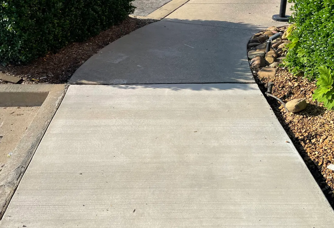 Concrete sidewalk leading to a building entrance