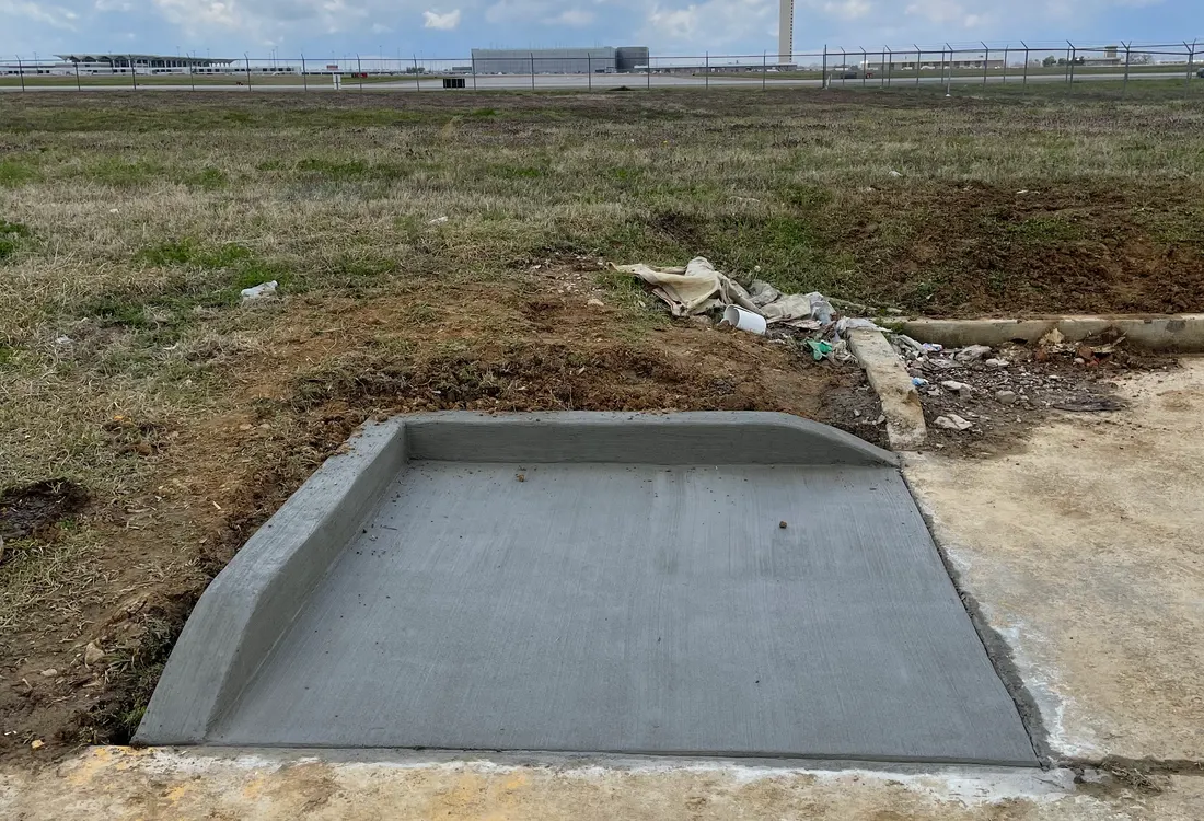 Concrete pad poured in an open rural field