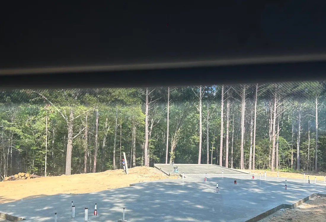 Freshly poured slab in a wooded clearing