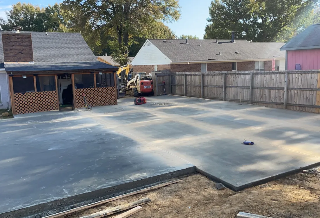 Large finished concrete surface beside a brick building