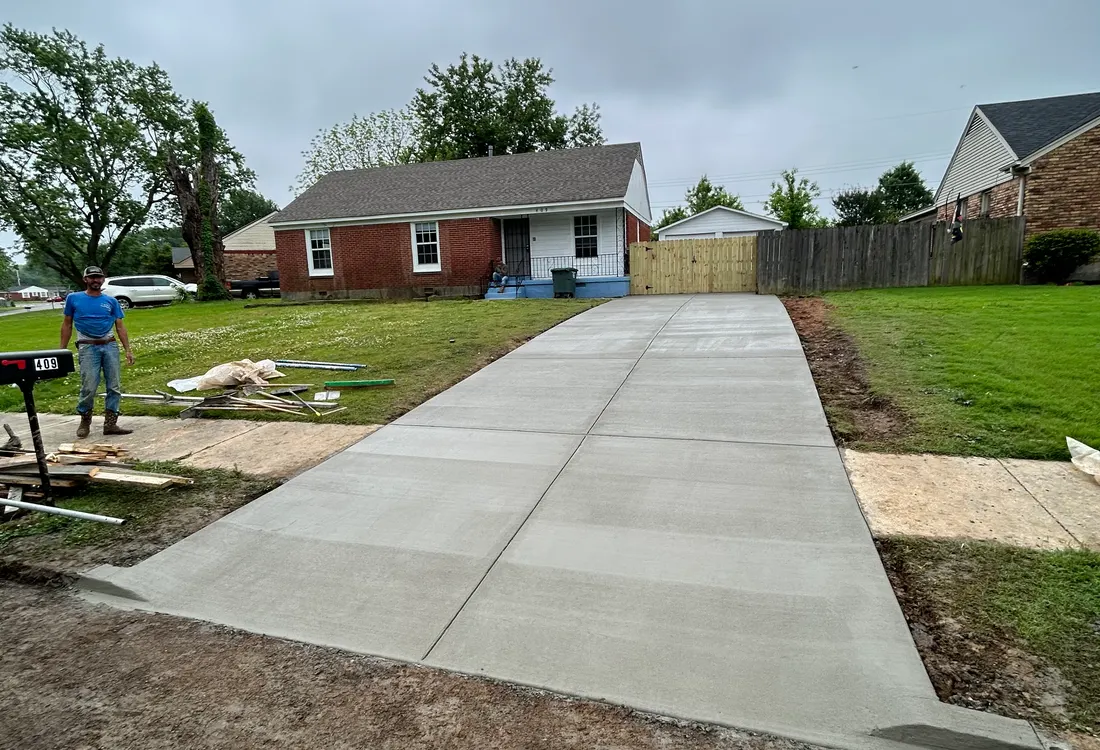 Completed wide concrete driveway meeting the street