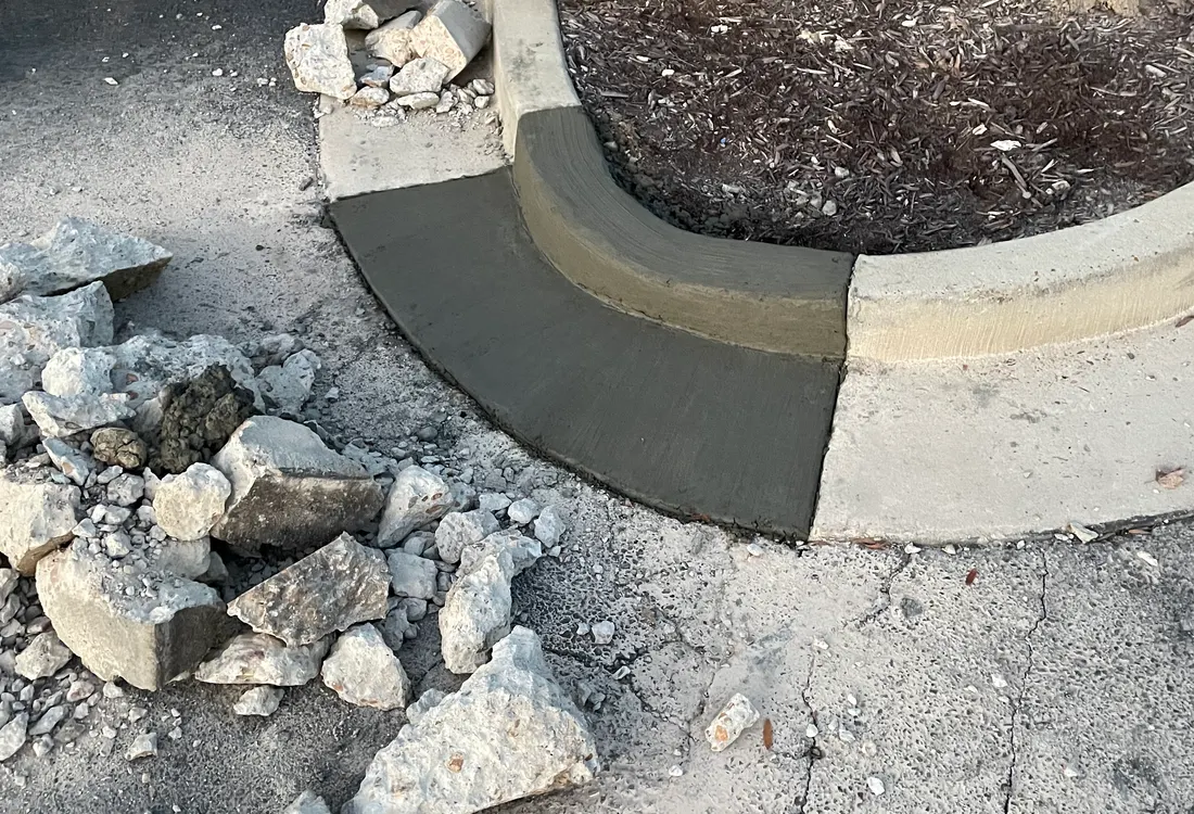 New concrete section poured against older pavement with rubble beside it
