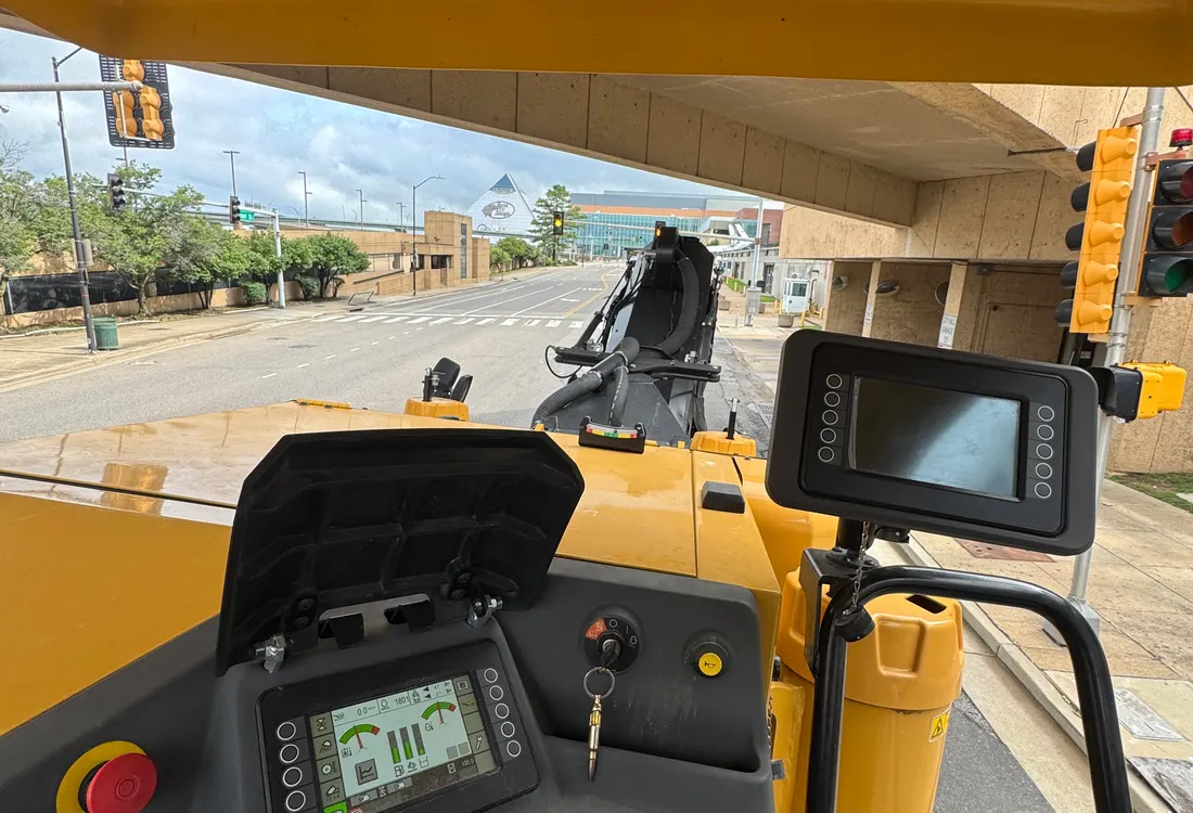 View from the cab of an asphalt paver working a street